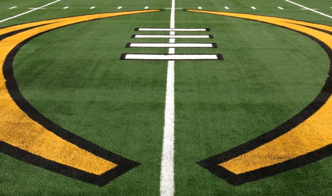 College Football Playoff logo on turf